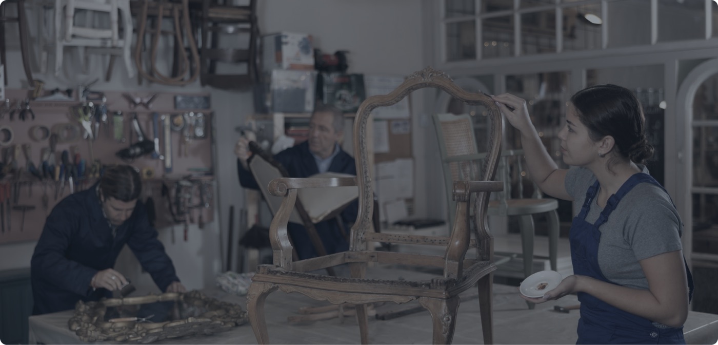 Restoration craftspeople at work in a furniture workshop